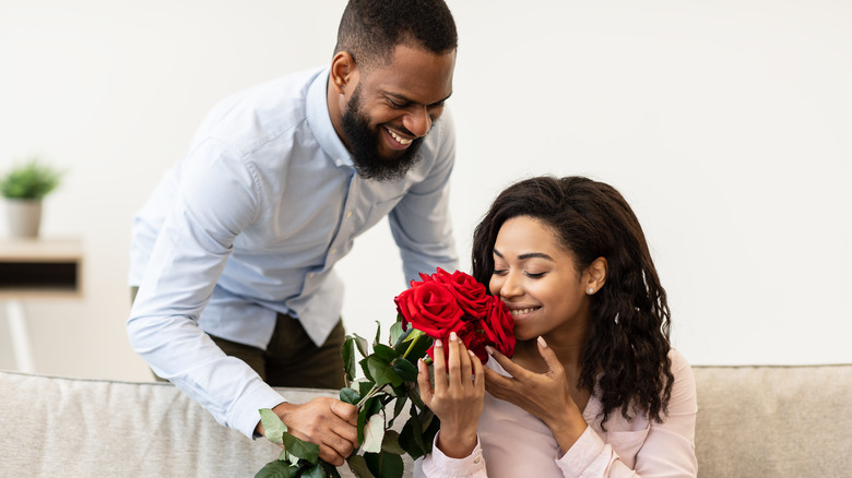 couple smelling roses 