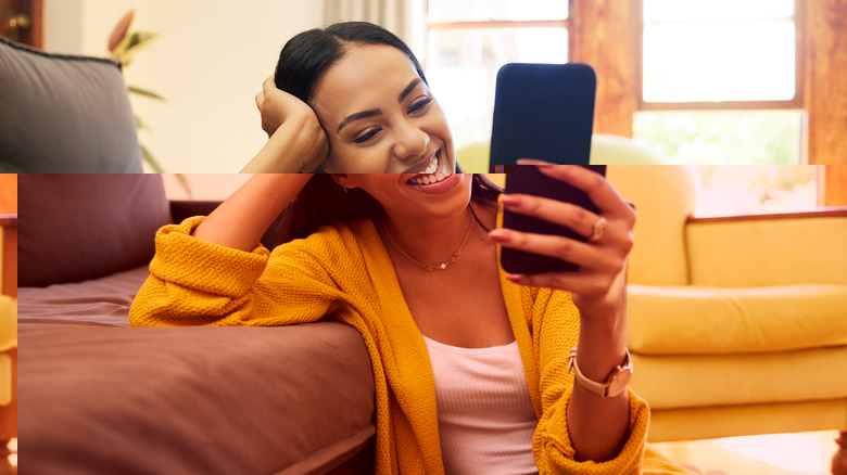 woman smiling at smartphone