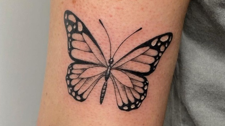 Shaded butterfly tattoo on arm