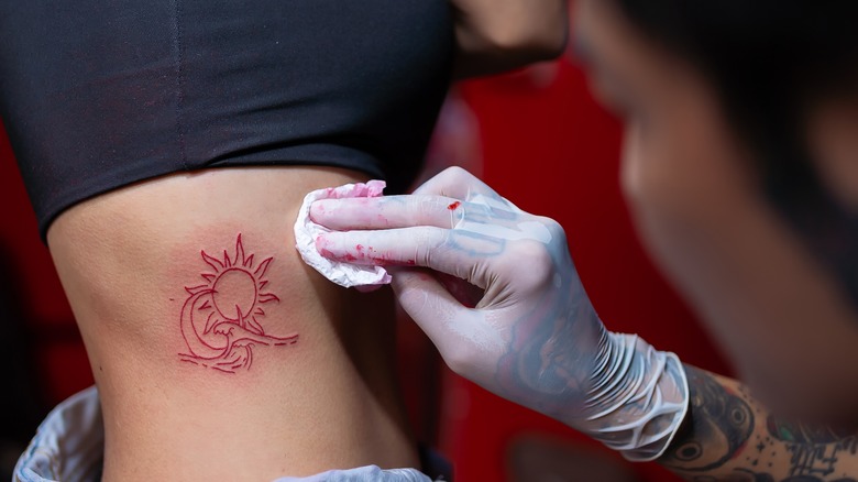 Tattoo artist cleaning tattoo
