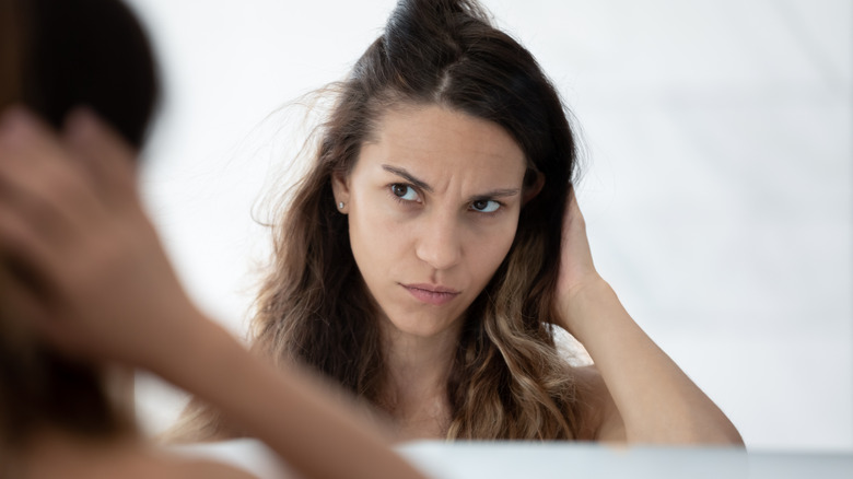 Woman looking unhappy about hair