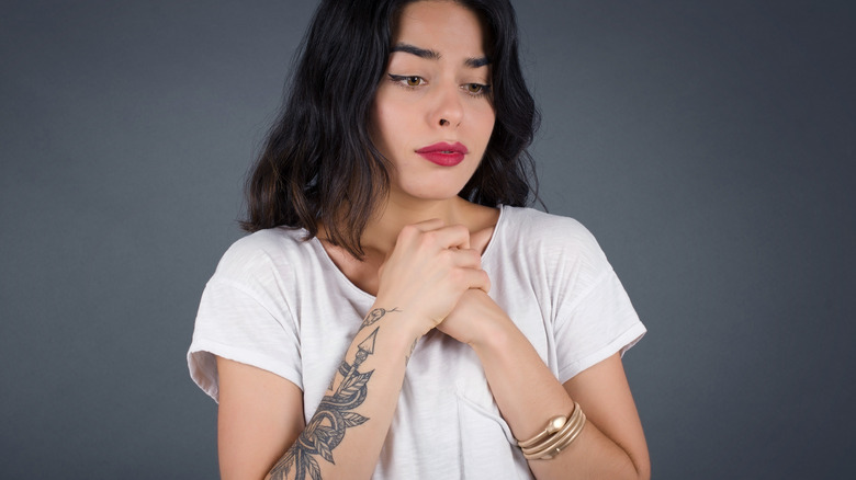 worried woman with tattoos