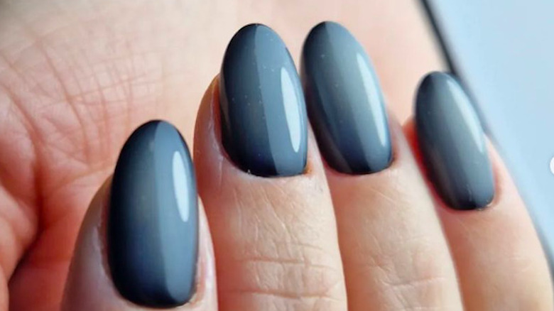 A woman wearing milky black nails