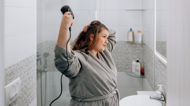 woman blow-drying hair