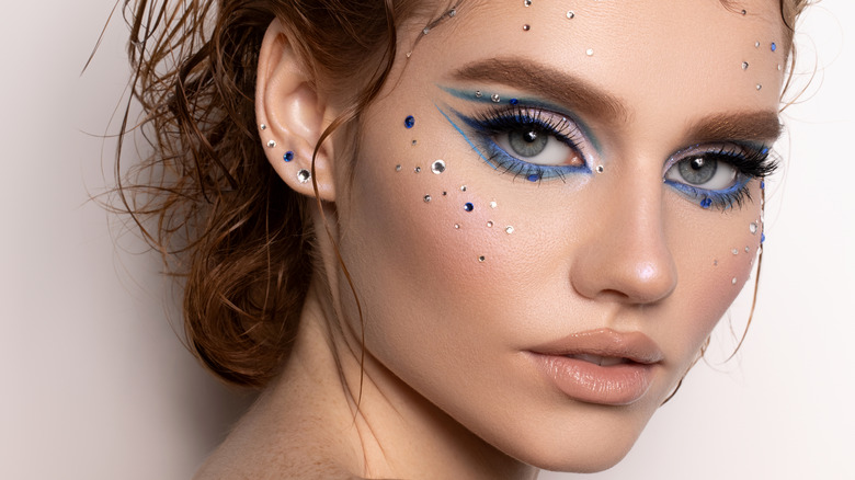 Woman wearing blue eyeliner and gems