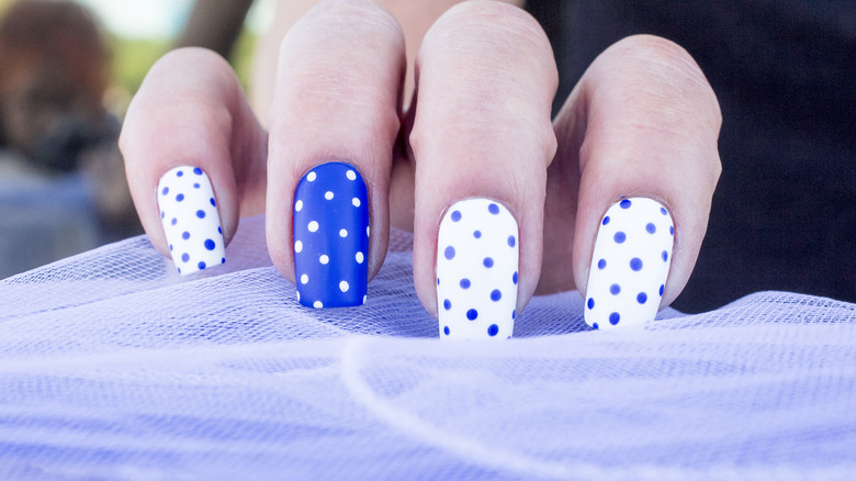 White-and-blue polka dot nail design