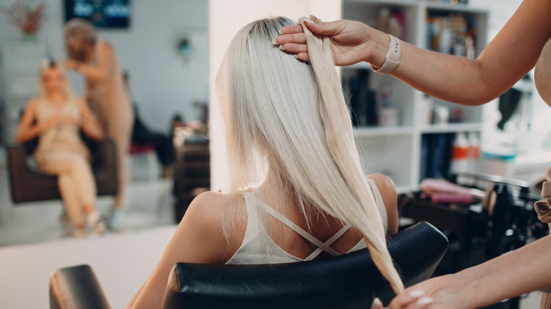 woman getting hair extensions