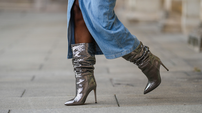 Woman wearing silver slouchy boots 
