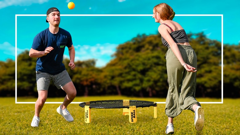 Man and woman playing Spikeball