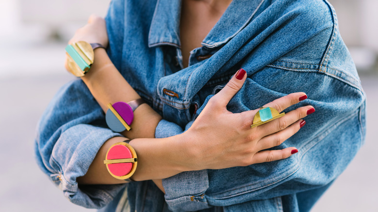 jean jacket styled with colorful jewelry