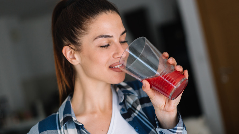 Woman drinks cherry juice