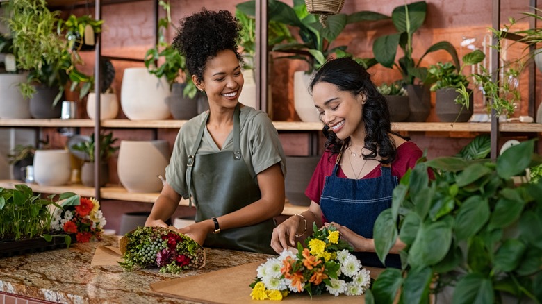 Two women work together at flower shop