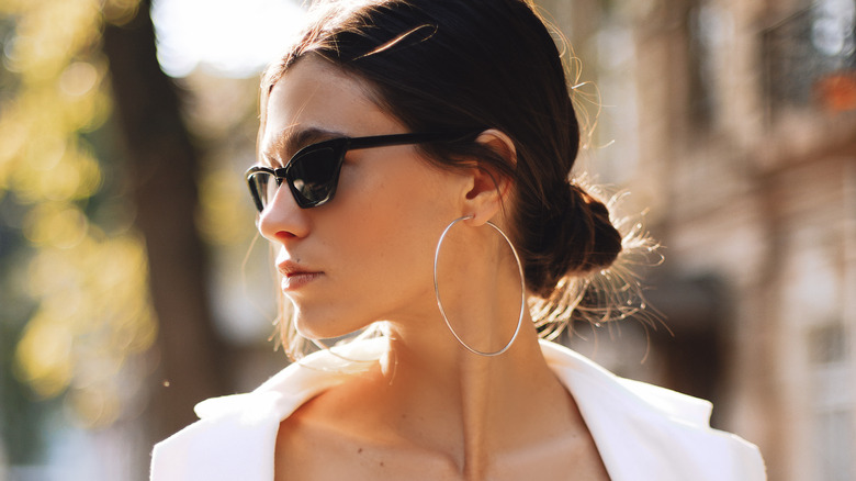 woman with sunglasses and low bun 