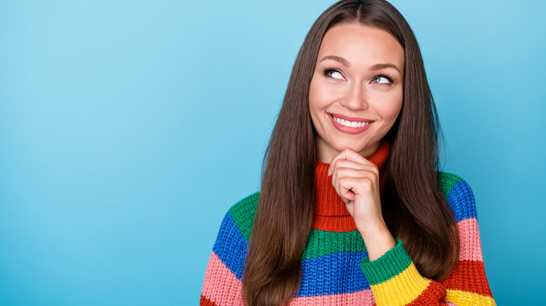 Woman wearing rainbow sweater