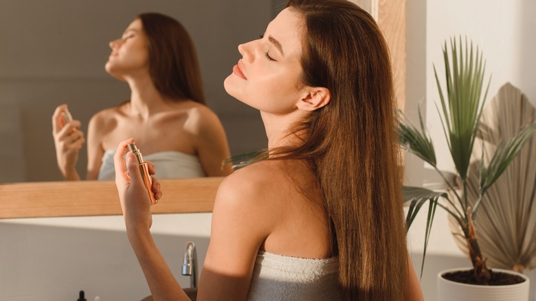 woman getting ready with perfume