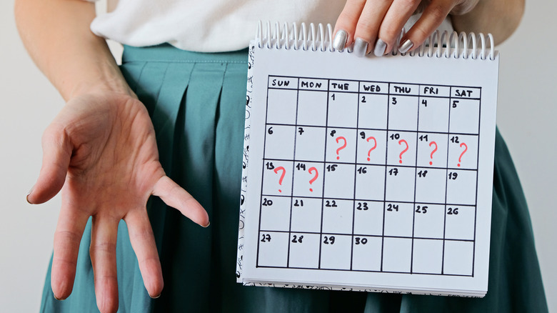 Woman holding a calendar for her period