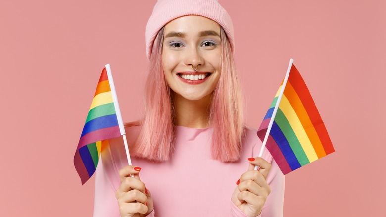 woman holding pride flags