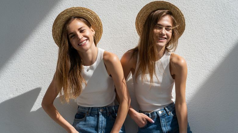 Smiling twins wearing hats 
